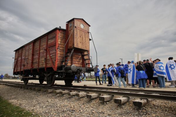 People take part in the annual "March of the Living" to commemorate the Holocaust, a yearly Holocaust remembrance march between the former death camps of Auschwitz and Birkenau, in Oswiecim, Poland, on Tuesday, April 14, 2026. (AP Photo/Beata Zawrzel)