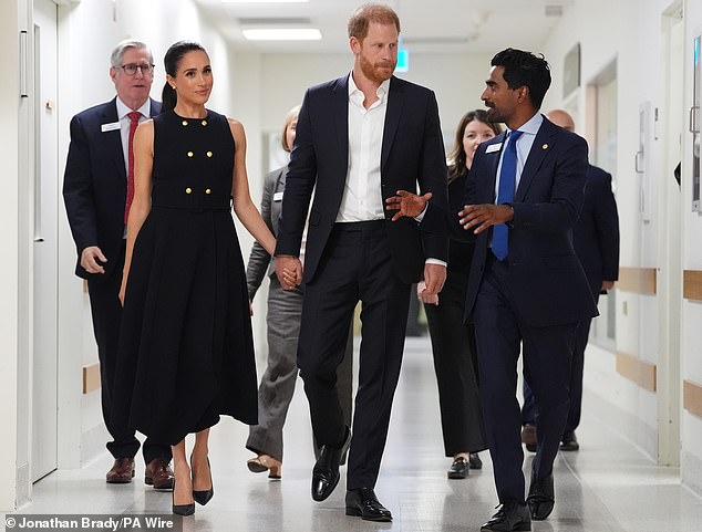 The Duke and Duchess of Sussex speak to Kog Ravindran (right), Chief of Staff to the CEO & Executive Director Communications, during a visit to the Royal Children's Hospital Melbourne, Victoria, on day one of the royal trip to Australia. Picture date: Tuesday April 14, 2026. PA Photo. Photo credit should read: Jonathan Brady/PA Wire