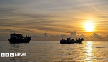 A boat carrying Rohingya refugees (left) sails ashore off the coast of Labuhan Haji in Southern Aceh province in 2024