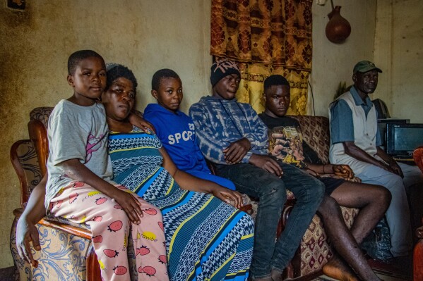 Caro Bih and her family pose for a photo in their living room in Bamenda, Cameroon, Monday, April 13, 2026. (AP Photo/Welba Yamo Pascal)