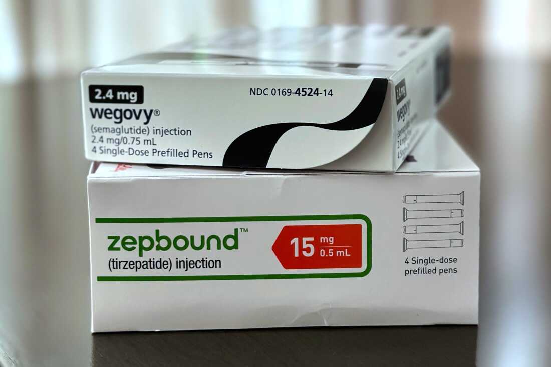 A box labeled Wegovy sits atop a box of Zepbound on a table.