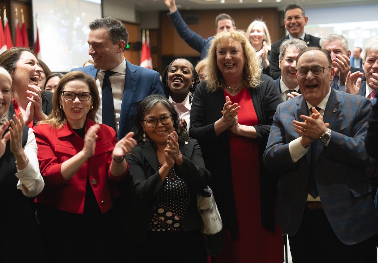 MP for Sarnia-Lambton-Bkejwanong Marilyn Gladu, MP for Nunavut Lori Idlout and other members of the Liberal caucus cheer as they wait for the prime minister to make his way to caucus with three new members before meeting on Parliament Hill in Ottawa,