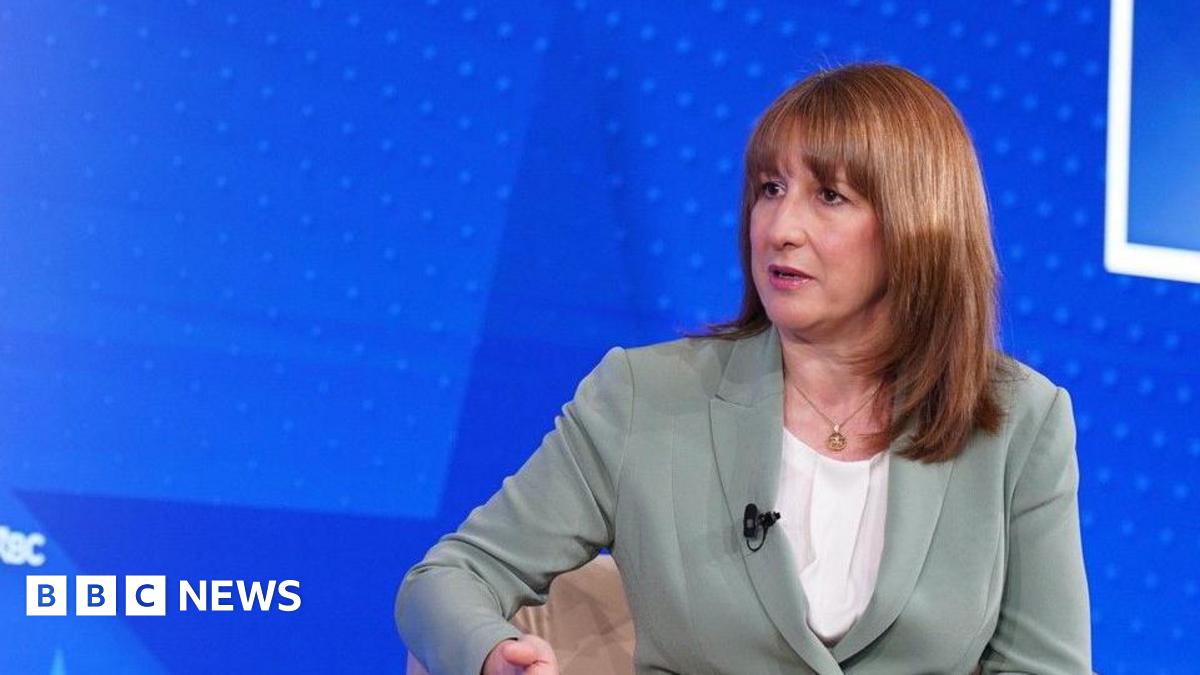 Head and shoulders of Rachel Reeve in a pale grey-green suit with clip microphone during the interview.