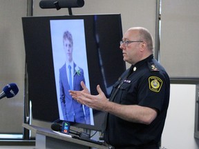 Sarnia's police chief speaks while standing next to a young man's photo in a homicide investigation