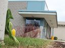 Flowers and hockey sticks were visible outside the patio entrance to the Lion's Den pub Sunday, in memory of Dane Nisbet. The former junior hockey player from Sarnia died after he was shot early Friday on the patio at Lambton College, police say. (Tyler Kula/ The Observer)