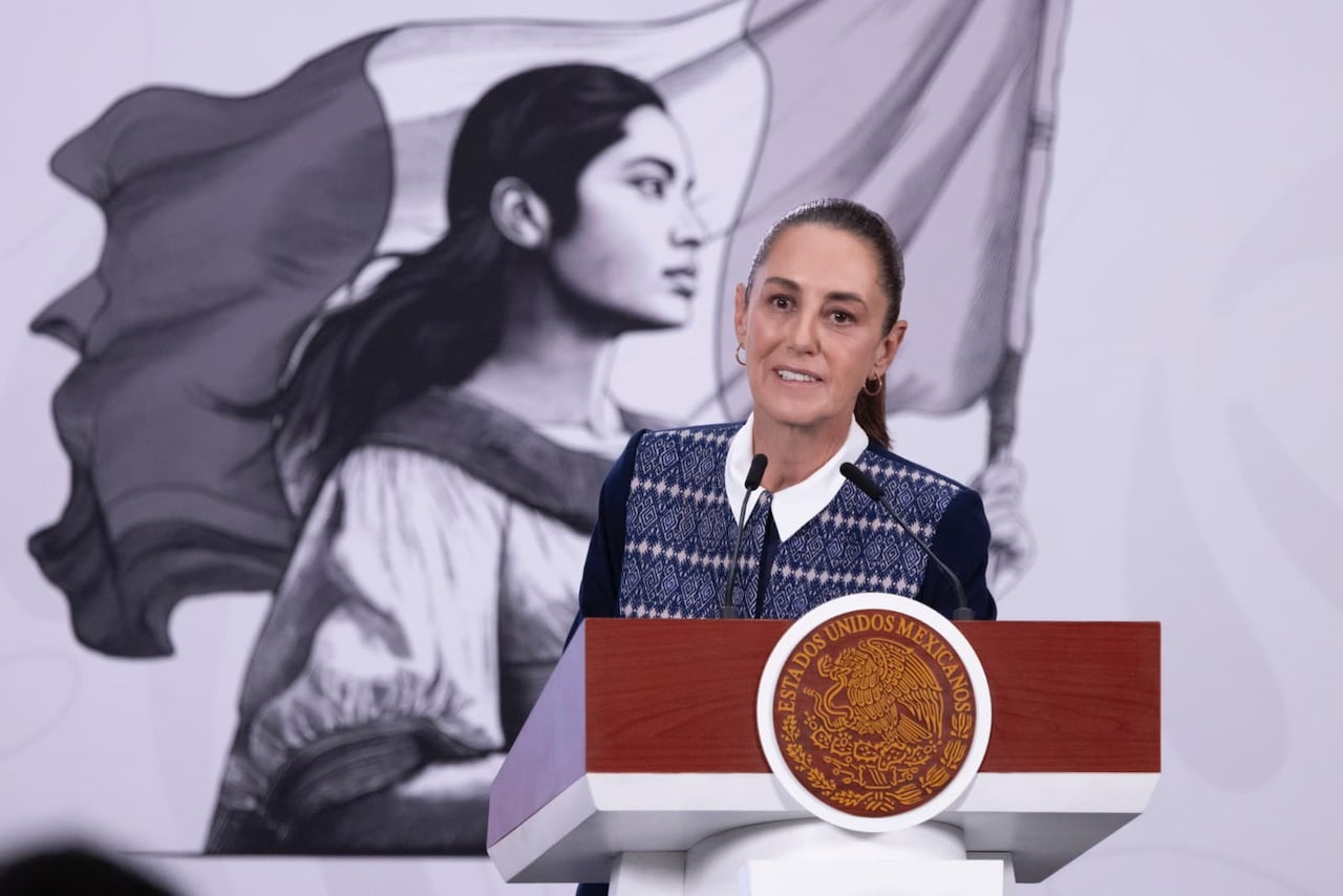 A woman stands behind a podium.