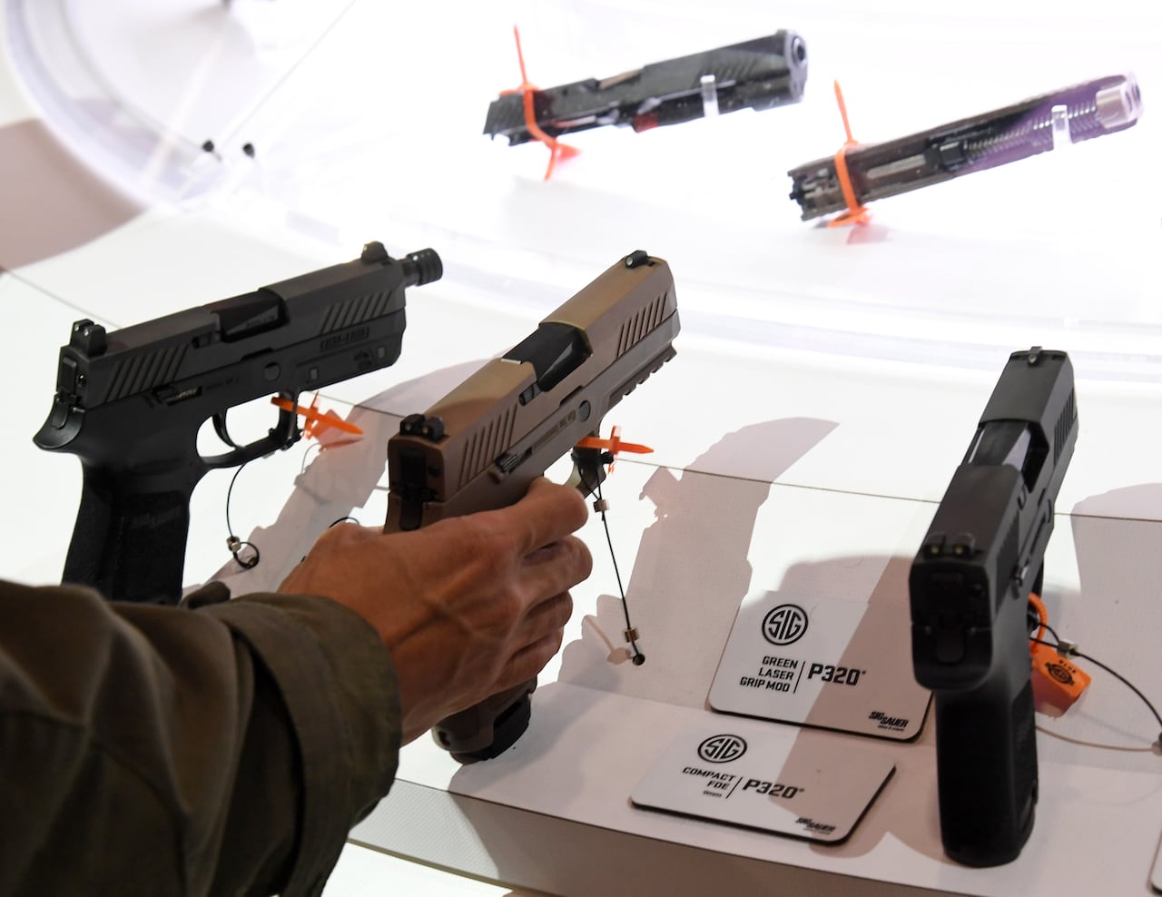 Three handguns are seen on display.
