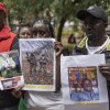 Relatives of Kenyan nationals conscripted by the Russian army in Ukraine pose with photos of their family members during a demonstration demanding urgent government action to repatriate their kin, in Nairobi on Feb.19, 2026.