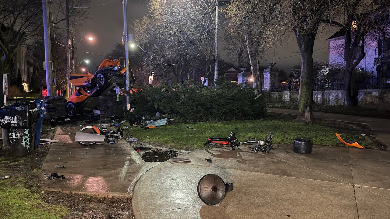 Debris litter a pathway near Casa Loma with a car crashed nearby