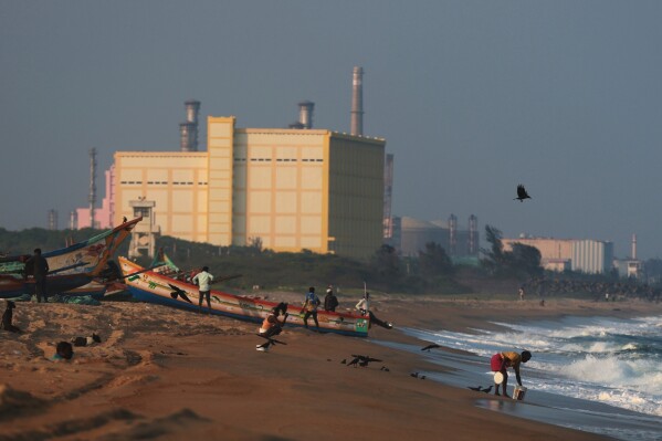 Fishermen tether a boat on the shore near the Madras Atomic Power Station, a nuclear power facility, at Kalpakkam, in the Indian state of Tamil Nadu, Feb. 10, 2025. (AP Photo/R. Parthibhan, File)