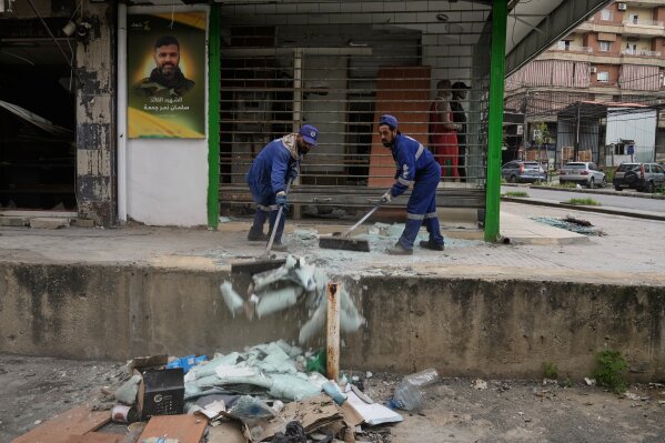 Municipal workers clean the streets in Dahiyeh, Beirut's southern suburbs, Lebanon, Friday, April 17, 2026, following a ceasefire between Israel and Hezbollah. (AP Photo/Bilal Hussein)