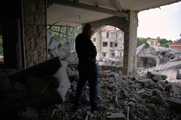 Assem Abdallah reacts as he enters his friend apartment destroyed in a Israeli airstrike in Kfar Roumman, southern Lebanon, Friday, April 17, 2026, following a ceasefire between Israel and Hezbollah. (AP Photo/Hassan Ammar)