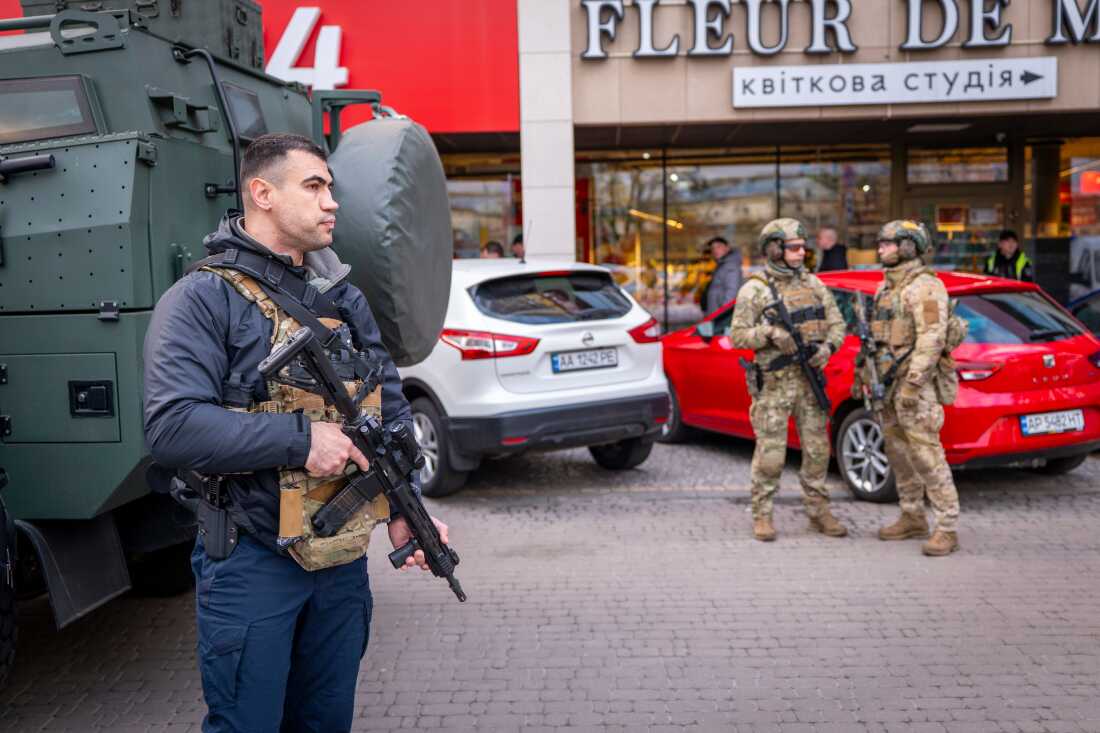 Police officers are seen at the site where a gunman killed at least six people in the streets before being shot dead by police, in Kyiv, Ukraine, Saturday, April 18, 2026.