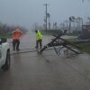 A utility pole blocks the road in Saipan on Wednesday as a super typhoon with ferocious winds and relentless rains, shredded tin roofs and forced residents to take cover from flying tree limbs.