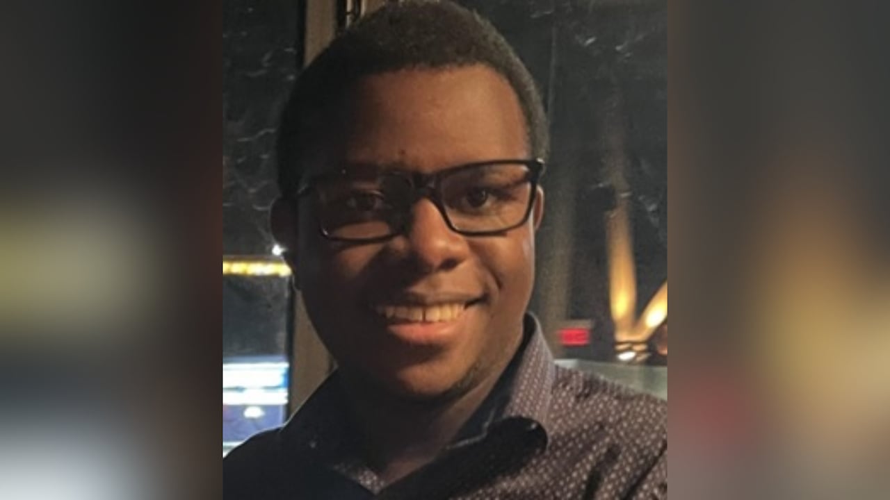 A man with glasses, smiling