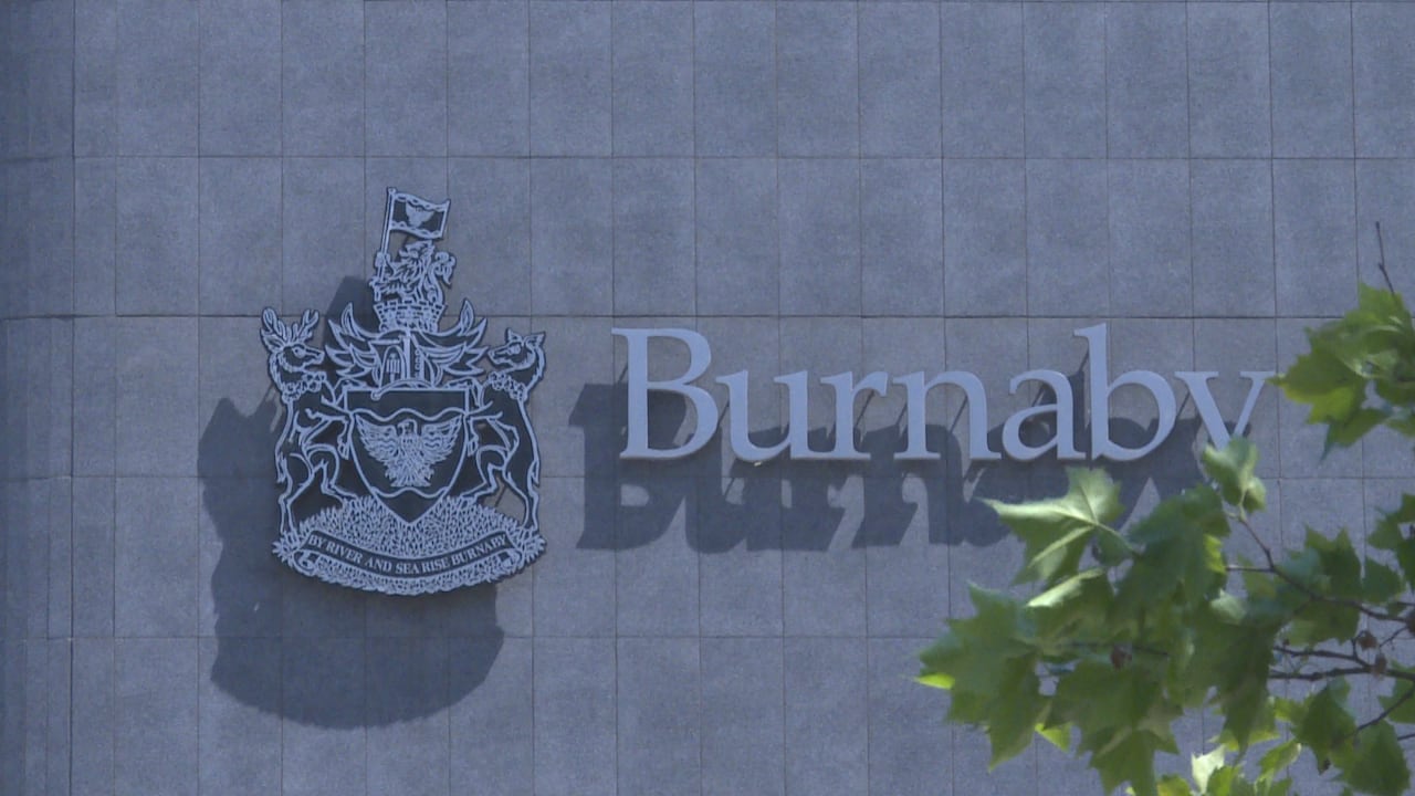 A close up of a sign that says 'Burnaby' and a coat of arms.