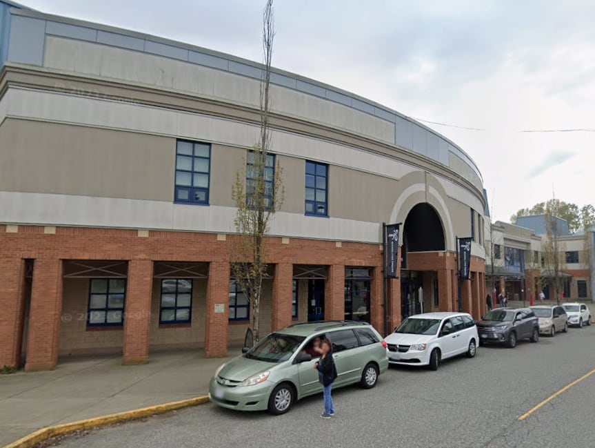 A large theatre building is seen on a cloudy day.
