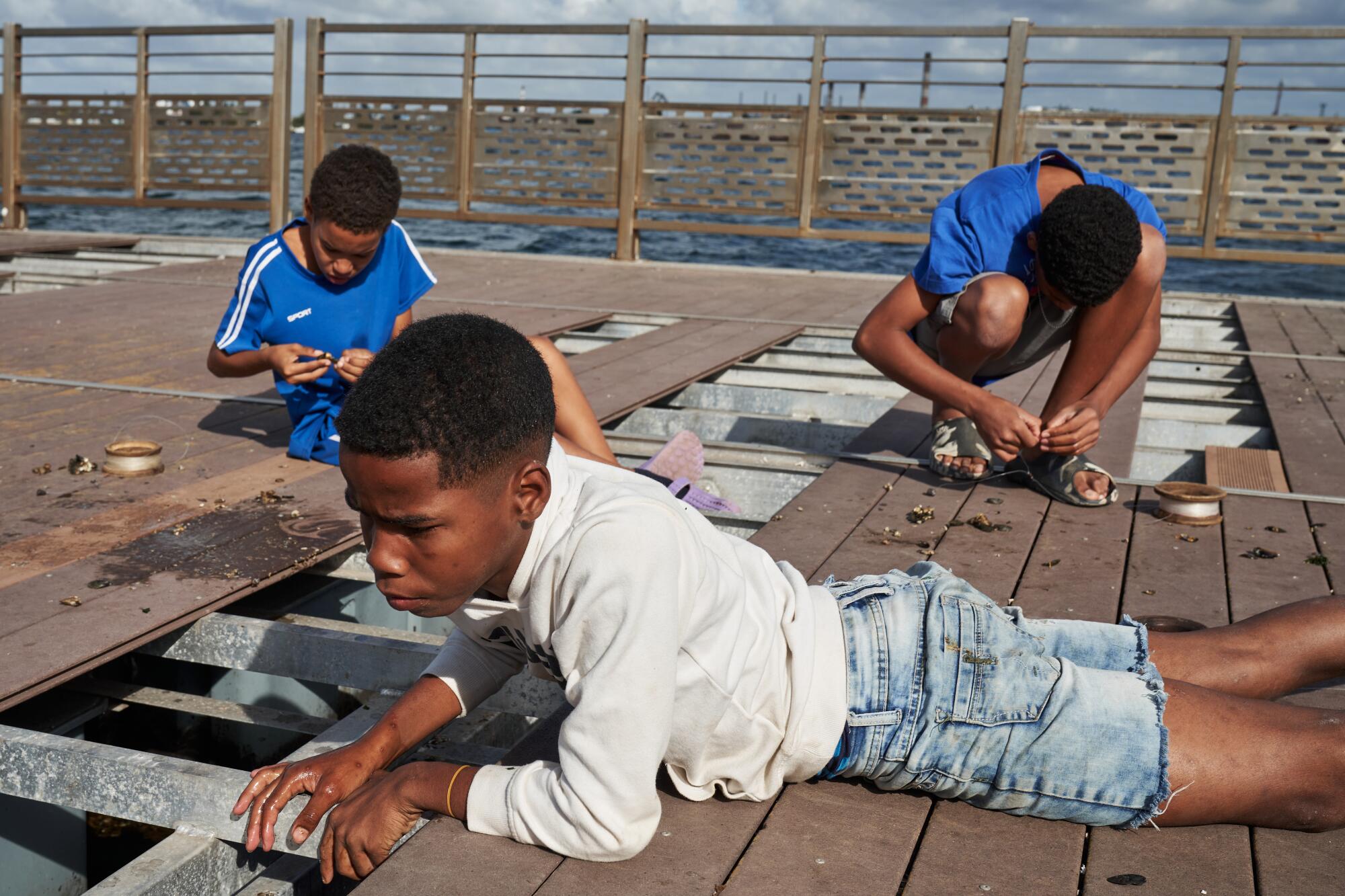 Children fish at the floating pier in the Old Havana neighborhood in the Cuban capital.