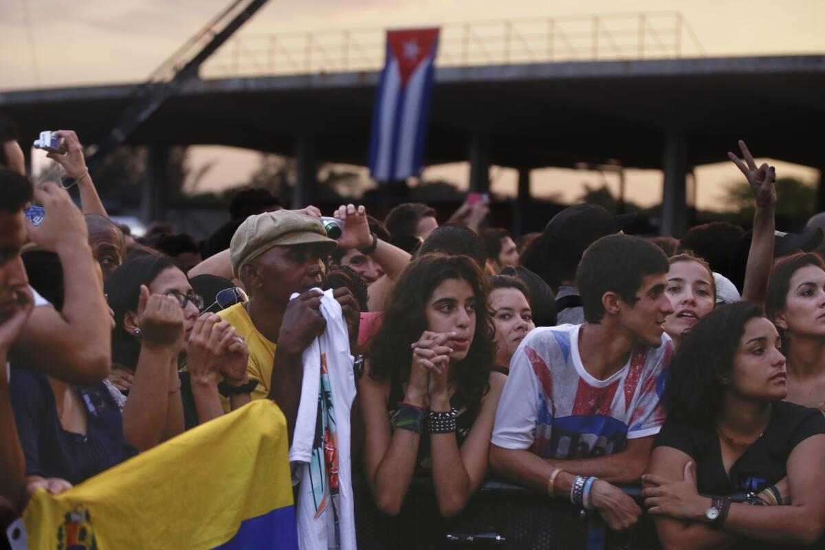 Crowds listen to The Rolling Stones perform