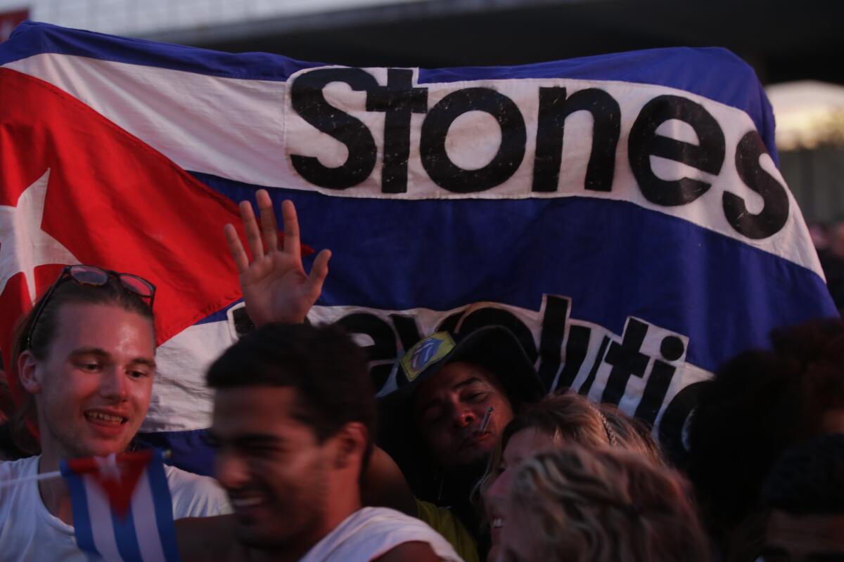 Crowds listen to The Rolling Stones perform