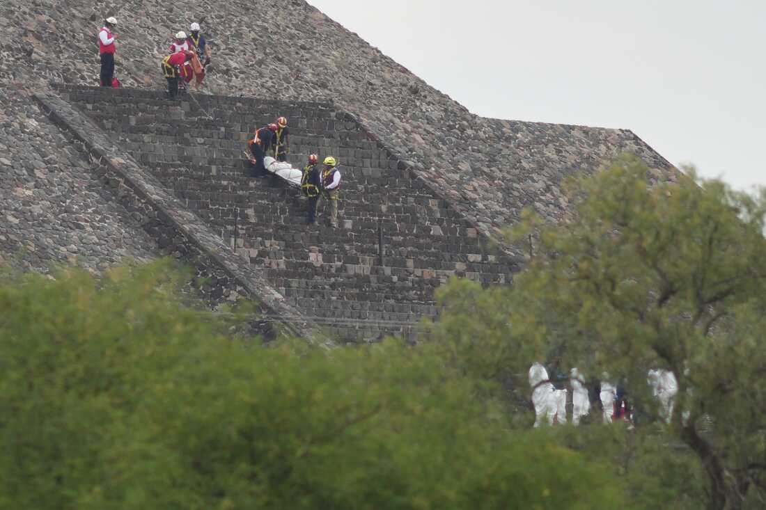 Forensic workers carry the body of a victim down a pyramid after authorities said a gunman opened fire, in Teotihuacan, Mexico, Monday, April 20, 2026.