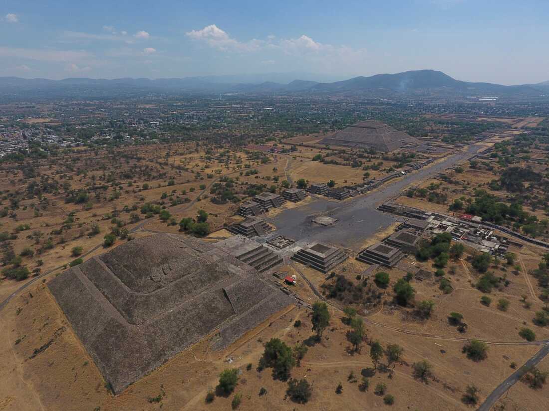 The Pyramid of the Moon, left, and the Pyramid of the Sun, back right, are seen along with smaller structures lining the Avenue of the Dead, in Teotihuacan, Mexico, March 19, 2020.