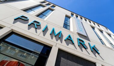 Primark storefront with shoppers entering and exiting, showcasing the latest fashion trends and bustling retail activity.