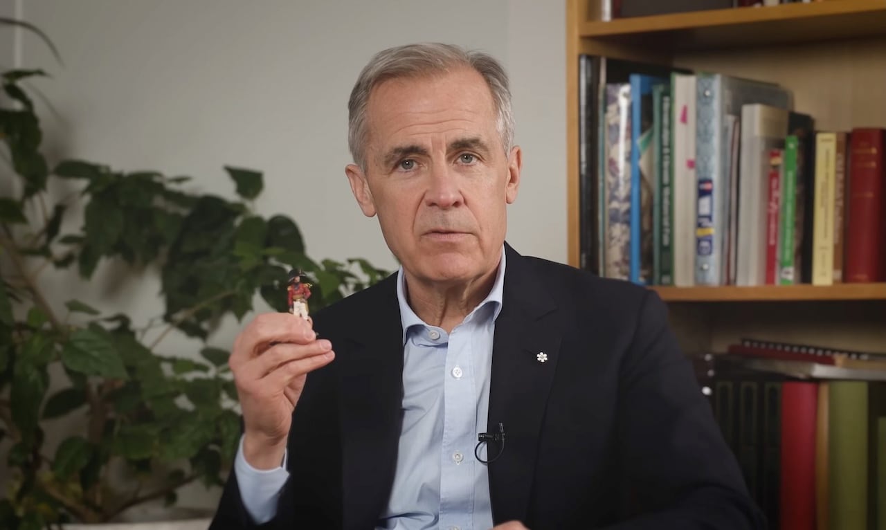 Prime Minister Mark Carney holds up a figurine of celebrated War of 1812 general Sir Isaac Brock during a video address.