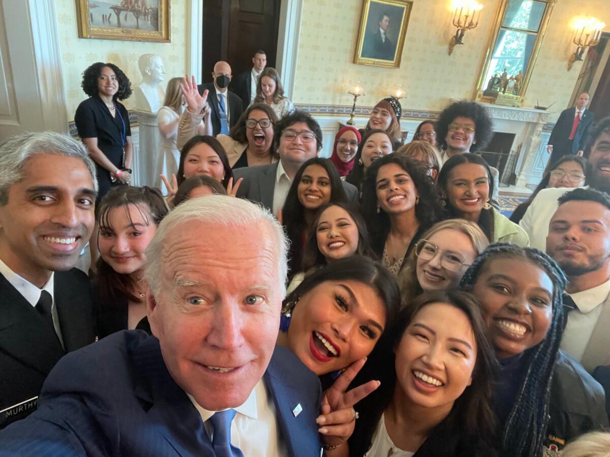 Then-President Biden taking a selfie with student leaders from Active Minds, including Meera Varma, in 2022