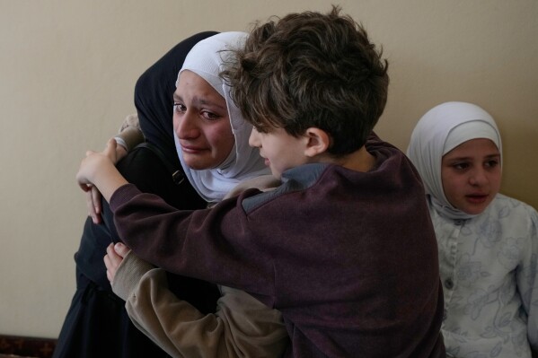 Relatives of Ghadir Baalbaki, 19, who was killed on Tuesday in an Israeli airstrike, mourn during her funeral in the southern port city of Tyre, Lebanon, Wednesday, April 15, 2026. (AP Photo/Hussein Malla)
