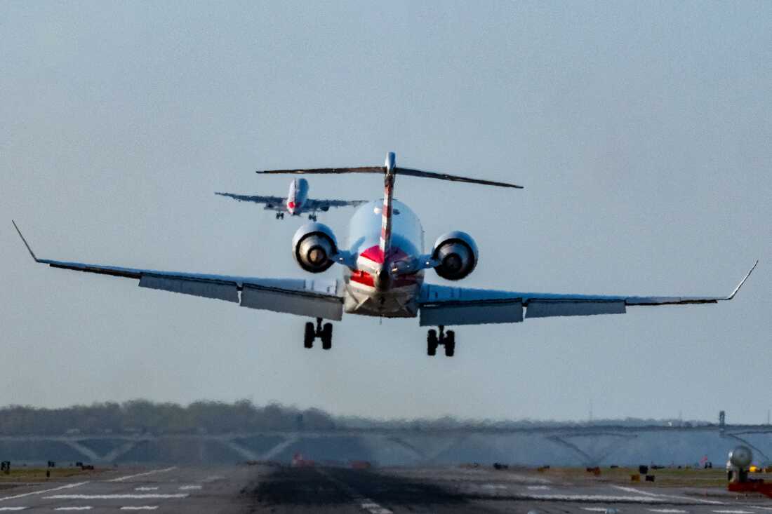 The FAA says it wants to build a brand new air traffic control system that can use software to prevent conflicts, delays and cancellations. Here, passenger jets land and take off at Reagan National Airport in Washington, D.C., in March. Last year, the airport saw a tragic midair collision between a regional airliner and a military helicopter.