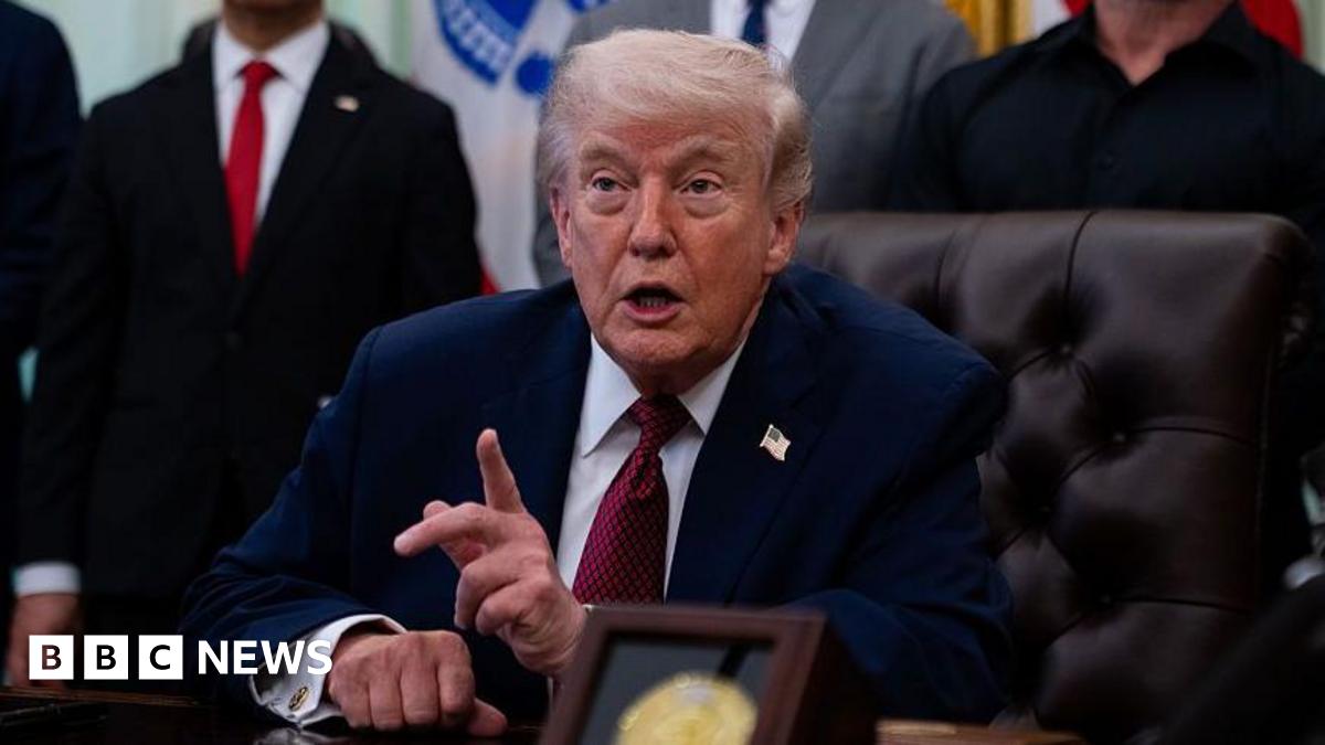 Trump points his finger as he speaks in the Oval Office with his supporters standing behind him