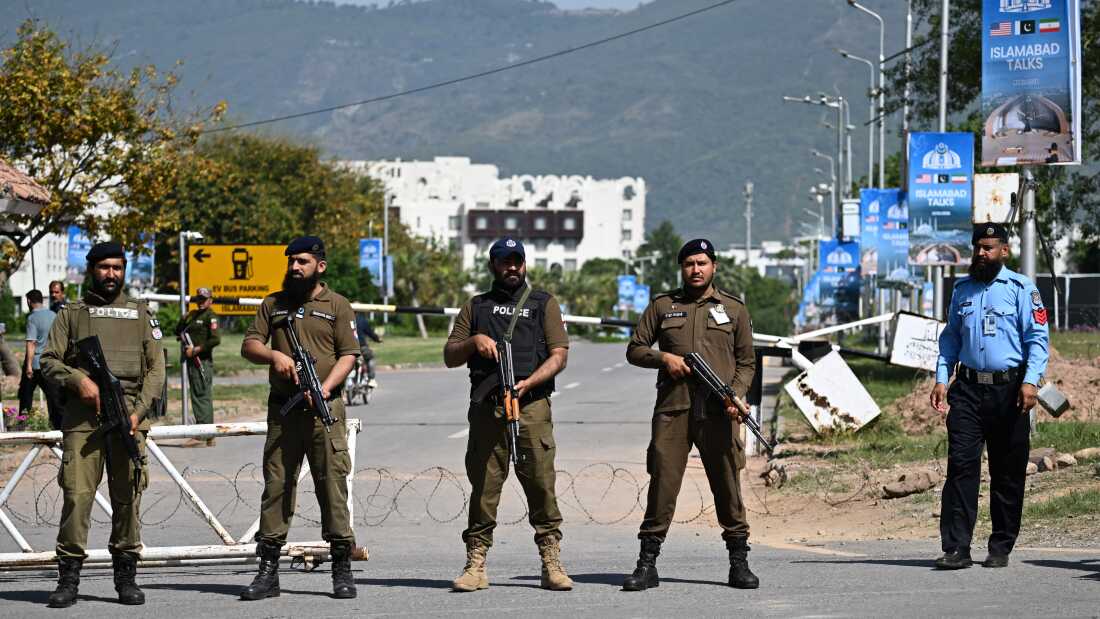 Security personnel stand guard at a security checkpost along a road temporarily closed near the Serena Hotel at the Red Zone area in Islamabad on April 20 ahead of anticipated U.S.-Iran peace talks.