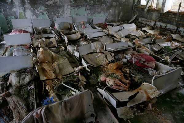 Beds sit in a room of an abandoned kindergarten in the deserted town of Pripyat, Ukraine, Nov. 27, 2012, which housed Chernobyl nuclear power plant workers and their families. (AP Photo/Efrem Lukatsky, File)