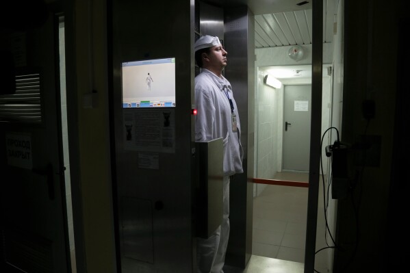 A worker checks radiation levels after leaving a nuclear waste storage site at the Chernobyl nuclear power plant in Chernobyl, Ukraine, March 23, 2016. (AP Photo/Efrem Lukatsky, File)