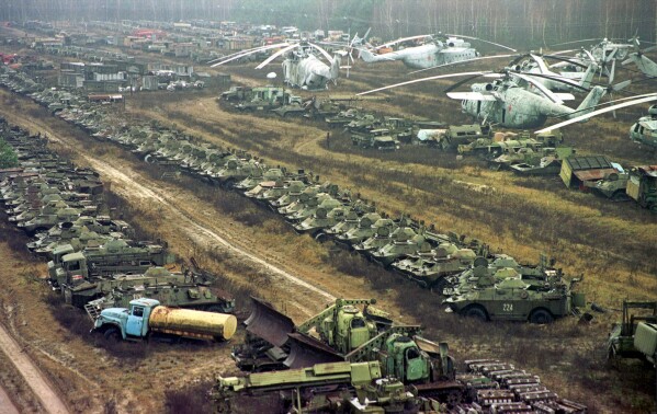 About 1,350 Soviet military helicopters, buses, bulldozers, tankers, transporters, fire engines and ambulances, all highly contaminated with radiation, sit abandoned in a junkyard, in Chernobyl, Ukraine, Nov. 10, 2000, after being used in cleanup operations following the 1986 explosion in the Chernobyl nuclear power plant. (AP Photo/Efrem Lukatsky, File )