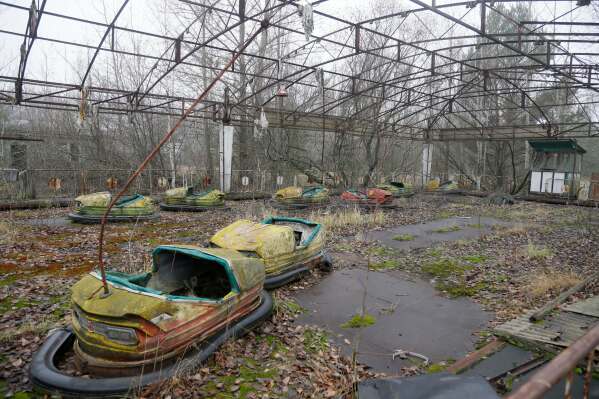 Bumper cars sit in a playground in the deserted town of Pripyat, Ukraine, Nov. 27, 2012, once home to people whose lives were connected to the nearby Chernobyl nuclear power plant. (AP Photo/Efrem Lukatsky, File)