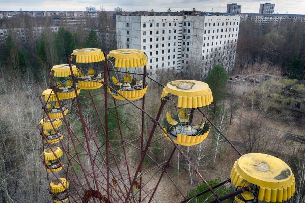 An abandoned Ferris wheel stands in a city park, April 15, 2021, in the abandoned town of Pripyat, Ukraine, once home to workers and their families whose lives were connected to the nearby Chernobyl nuclear power plant. (AP Photo/Efrem Lukatsky, File)