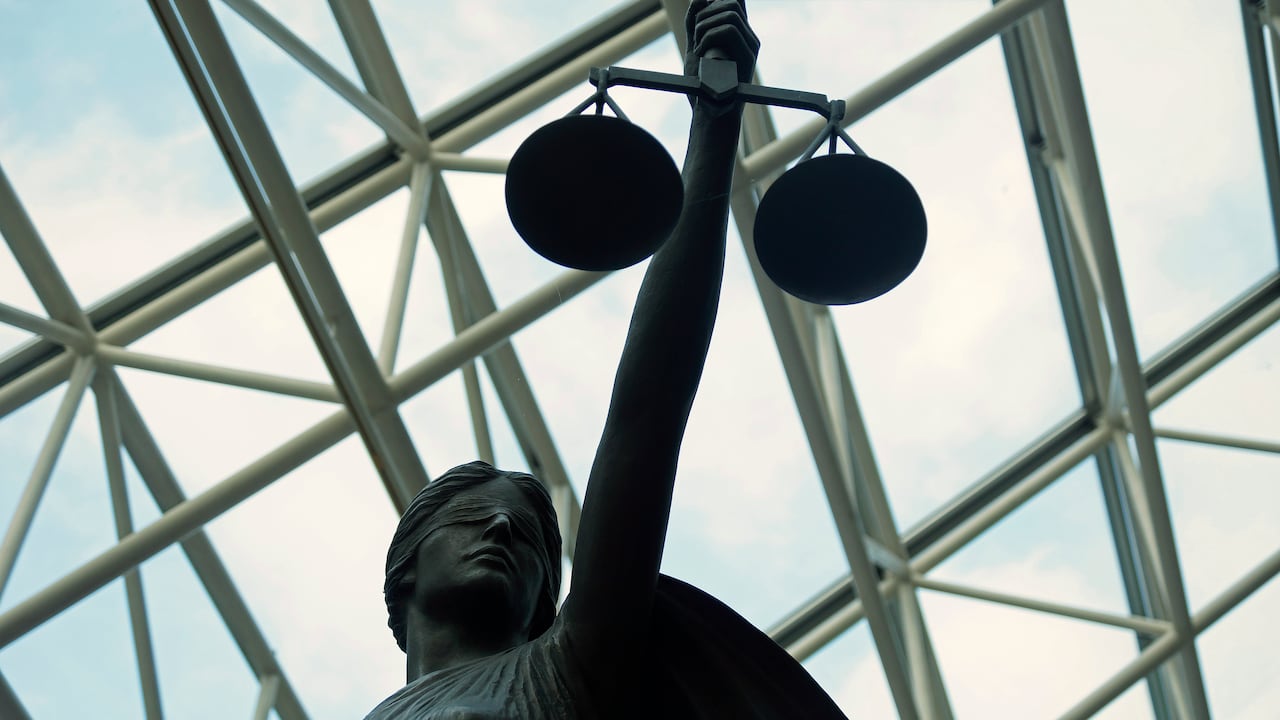 A statue of a blind woman holding up the scales of justice.