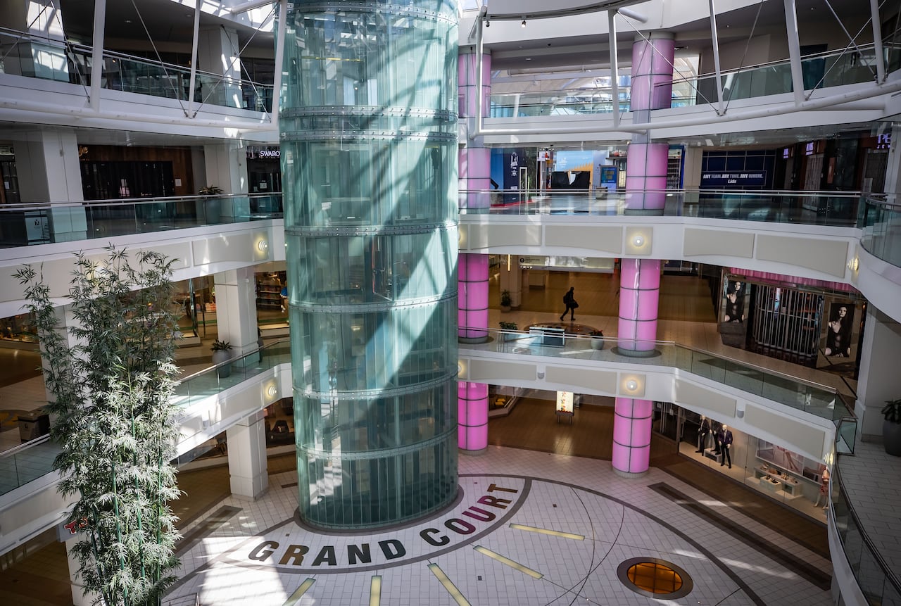 A person walks through a deserted mall.