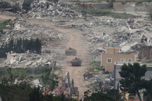 Israeli army vehicles and bulldozers operate in southern Lebanon, as seen from northern Israel, Wednesday, April 15, 2026. (AP Photo/Ariel Schalit)