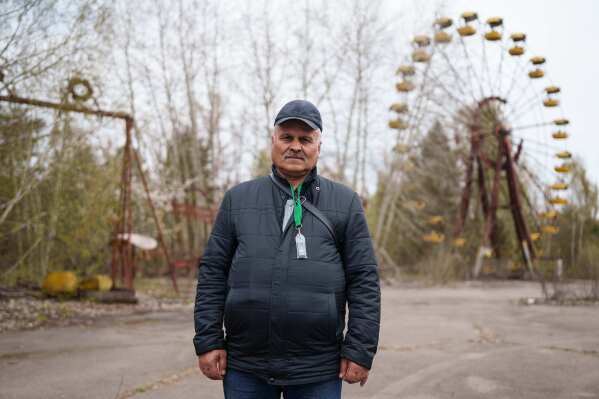 Volodymyr Vechirko, 62, one of the workers who helped decontaminate the area around the Chernobyl nuclear power plant after the 1986 accident, poses for a portrait in the nearby abandoned town of Prypiat, Ukraine, Tuesday, April 21, 2026. (AP Photo/Evgeniy Maloletka)