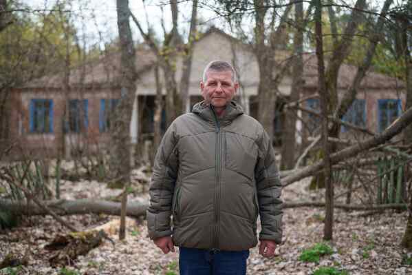 Anatolii Taranenko, 62, one of the workers sent to help clean up contamination from the Chernobyl nuclear power plant accident, poses for a portrait near the facility in Chernobyl, Ukraine, Tuesday, April 21, 2026. (AP Photo/Evgeniy Maloletka)
