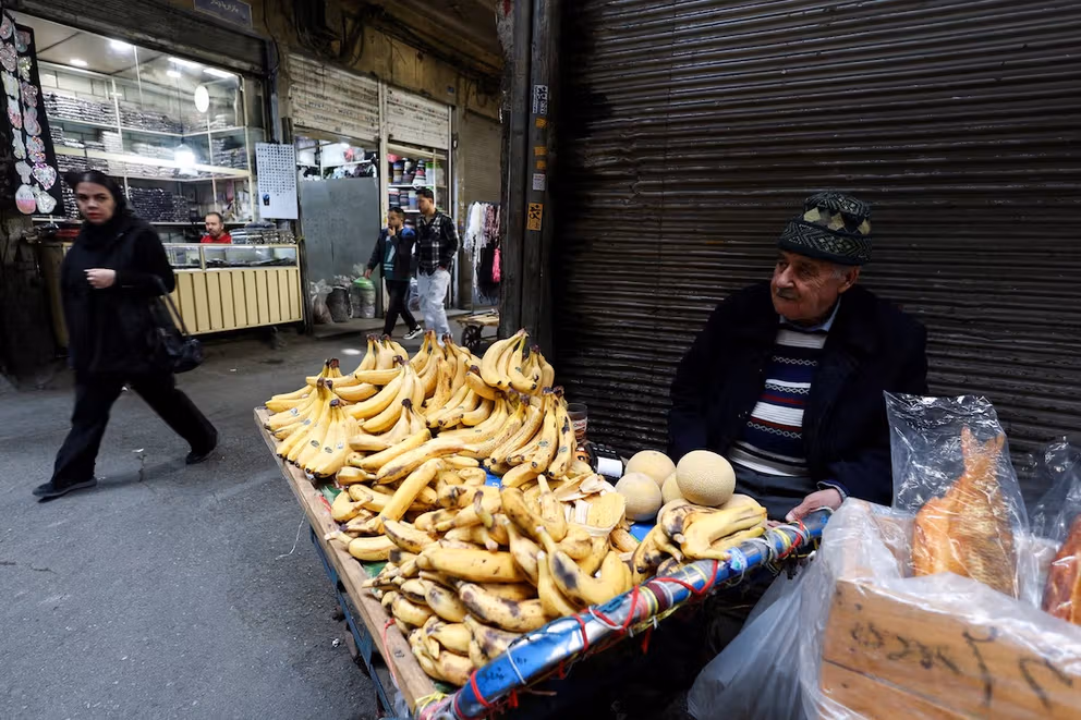 man sells fruit at the Grand Bazaar, amid the US-Israeli conflict with Iran, in Tehran, Iran, March 18, 2026.