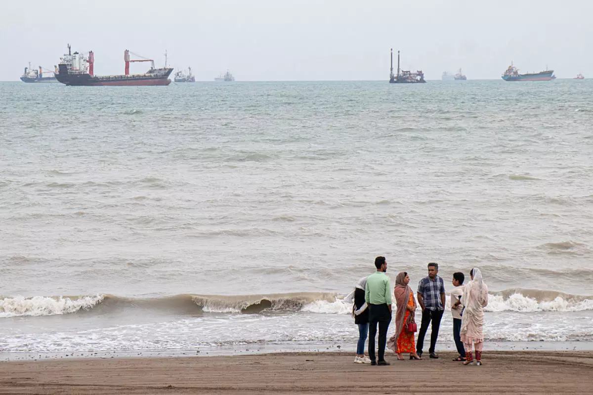 In this picture obtained from Iran's ISNA news agency on April 24, Iranians are seen at Suru Beach in Bandar Abbas along the Strait of Hormuz.