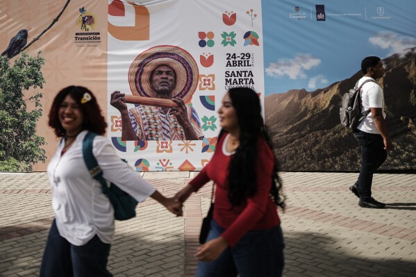 People arrive at a conference aimed at transitioning away from fossil fuels Monday, April 27, 2026, in Santa Marta, Colombia. (AP Photo/Ivan Valencia)