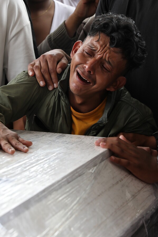 A relative mourns during a funeral for a family member who was killed in an attack on the Pan-American Highway that authorities blamed on dissident former FARC rebels, in Cajibio, Colombia, April 28, 2026. (AP Photo/Santiago Saldarriaga, File)