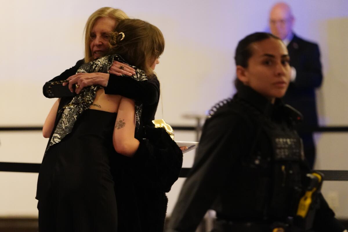People react after an incident at the annual White House Correspondents' Assn. dinner.