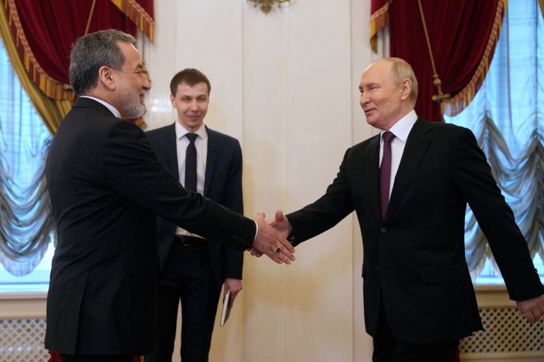 Russian President Vladimir Putin shakes hands with Iranian Foreign Minister Abbas Araqchi during a meeting at the Boris Yeltsin Presidential Library in Saint Petersburg, Russia April 27, 2026. Dmitri Lovetsky/Pool via REUTERS