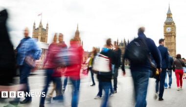 People walking in front of the Houses of Parliament in London